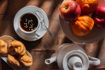Morning breakfast - tea and light snack on a background dark