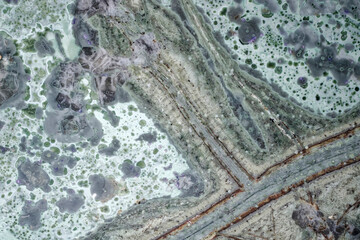 A macro photograph of Tinguaite from Khibiny under a microscope, a rare igneous ornamental stone is an abstract geological texture for science, education, research