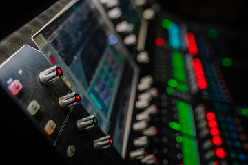 Audio mixing console with illuminated buttons and knobs, showcasing vibrant colors and intricate...
