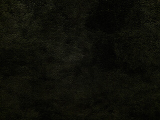 dark textured black fabric closeup with subtle green hues evoking mysterious eerie mood ideal for horror wallpaper or spooky banner background
