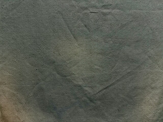 crumpled olive green canvas texture with subtle gradient fold evoking rustic minimalism for wallpaper or design background