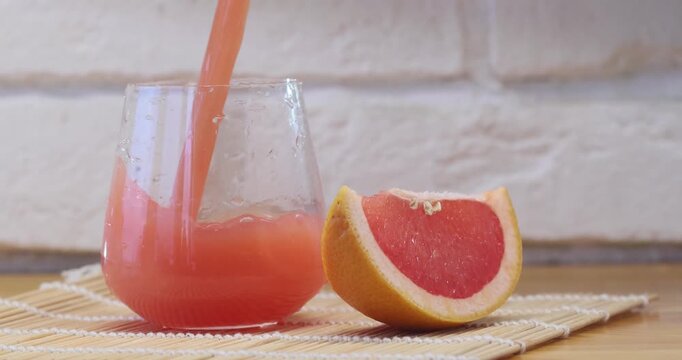 Delicious fresh squeezed grapefruit juice in  transparent glass