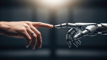 Human hand reaching out to a robotic hand in a symbolic gesture.