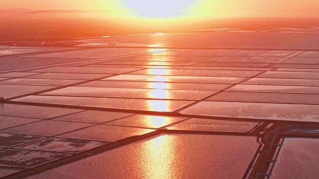 Aerial view of the Margherita di Savoia salt mines at sunset in Puglia, Italy