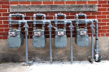 Residential building utility system with gas meters and metal pipes