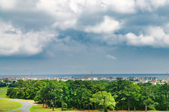Oceanfront townscape and green pine trees under dramatic weather at the Outer Banks