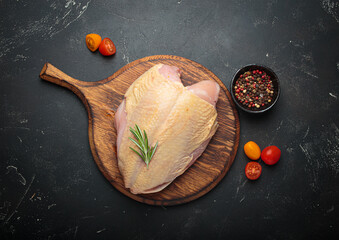 Raw chicken breast fillet wooden cutting board rosemary pepper cooking healthy protein