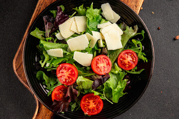Parmesan cheese vegetable salad tomato, arugula, green leaf lettuce healthy food main course ingredient appetizer fresh tasty gourmet food background food top view copy space vegetarian food