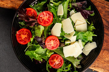 Parmesan cheese vegetable salad tomato, arugula, green leaf lettuce healthy food main course ingredient appetizer fresh tasty gourmet food background food top view copy space vegetarian food