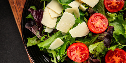 Parmesan cheese vegetable salad tomato, arugula, green leaf lettuce healthy food main course ingredient appetizer fresh tasty gourmet food background food top view copy space vegetarian food