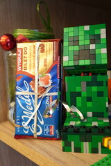 Fototapeta premium Gift of chocolate and a Minecraft Creeper made from LEGO bricks