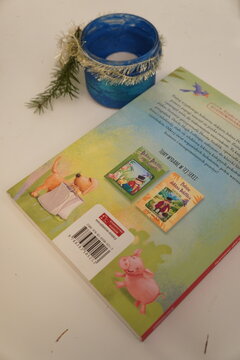 Children's book cover featuring cute animal illustrations and a festive candle holder