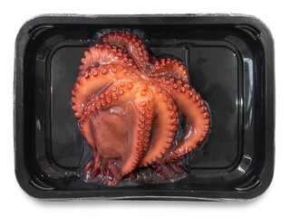 Pre-cooked octopus  vacuum-packed in black plastic trays isolated on white with clipping path included