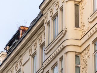 Obraz premium Facade of a historic corner building in Vienna with classic stucco and decorative architectural details