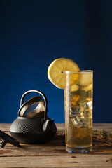 Enjoying Green Tea With Ice on a Wooden Table Under Soft Lighting