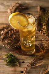 Green Tea With Ice and Lemon Served on a Wooden Table With Leaves Around