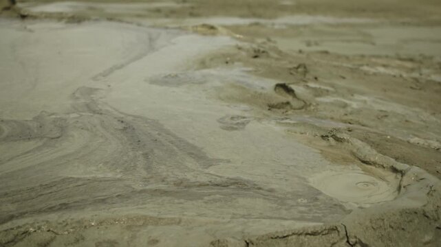 Hypnotic Close-Up Pan of Bubbling Mud at Berca Mud Volcanoes