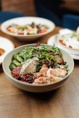 Explore various dishes featuring fresh ingredients and vibrant flavors from different cuisines on a wooden table setting