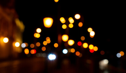 Blurred night city lights create an abstract composition, highlighting the vibrant colors and...