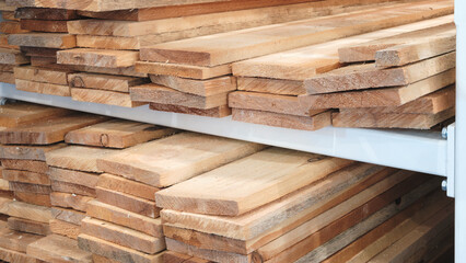 Stacks of cut wooden boards lie in a furniture transport factory or distribution warehouse for storage and delivery.