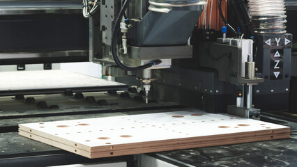 A modern woodworking cutting and drilling milling machine at a furniture factory © Aleksandr Matveev