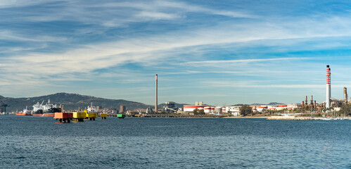 Naklejka premium Image showing an oil refinery and maritime fuel transport infrastructure in the Bay of Algeciras, Spain. Tankers moored at an industrial pier along the Mediterranean coastline.