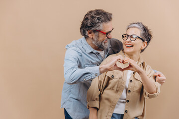 Senior couple making heart shape showing love
