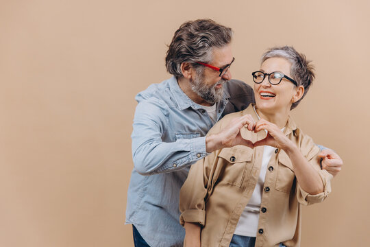 Senior couple making heart shape showing love