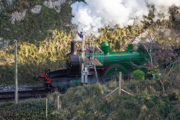 View from Corfe Castle of a Historic Steam Train Passing Through the Dorset Countryside, England