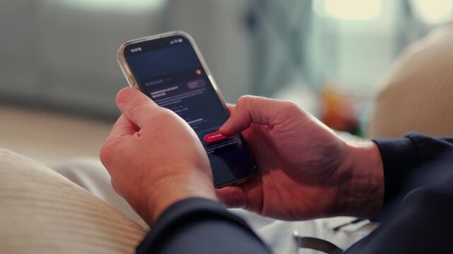 Middle Aged Man Gets Mobile Phone Notification of Suspicious Foreign Banking Transactions - FinTech Cybersecurity Mobile Banking Alerts Concept