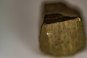 Pyritkristall auf einer weißen Fläche im Nahbereich dargestellt