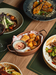 A delicious gourmet dinner plate featuring healthy chicken and rice served with fresh vegetable salad and a savory sauce for a balanced restaurant quality meal