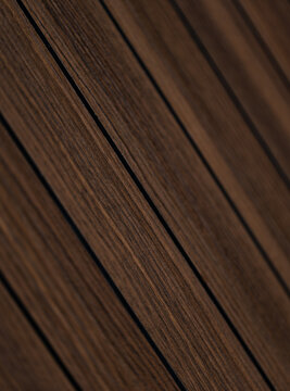 Close-up of dark brown wooden planks arranged diagonally showing natural grain texture and parallel lines