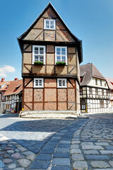 Historic Half-Timbered Townhouse in Quedlinburg with Cobblestone Street, Bright Daylight