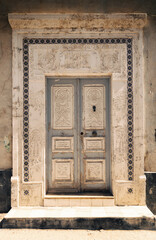 Decorative doors in the facades of buildings in the old town of Mahdia in northeastern Tunisia, on the Mediterranean Sea, travel background or wallpaper for your project