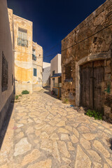 A narrow street in the old town of Mahdia in northeastern Tunisia on the Mediterranean Sea, a travel background or wallpaper for your project
