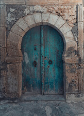 Decorative doors in the facades of buildings in the old town of Mahdia in northeastern Tunisia, on the Mediterranean Sea, travel background or wallpaper for your project