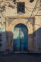 Decorative doors in the facades of buildings in the old town of Mahdia in northeastern Tunisia, on the Mediterranean Sea, travel background or wallpaper for your project