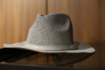 Gray hat placed in a wooden wardrobe