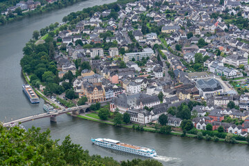 Aerial View of Historic Riverside Town with Bridge and Passenger Ship, Clear Daylight
