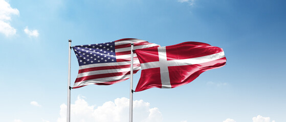 USA and Denmark Flags Flying Together Against Blue Sky