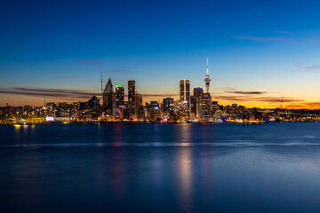 Auckland City Skyline at Night with Sky Tower Reflections on the Harbour