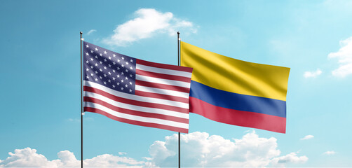 USA and Columbia Flags Flying Together Against Blue Sky