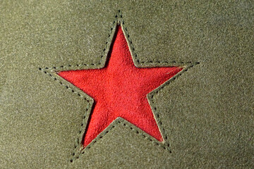 Red star symbol at green textile