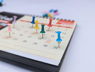 push pin on calendar event planner to set timetable organize schedule, event planning for business meeting or vacation plan. Organization and business planning concept