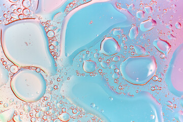 Abstract macro of liquid bubbles in soft blue and pink pastel tones. Delicate fluid texture ideal for beauty, skincare branding, wellness design, and feminine modern backgrounds