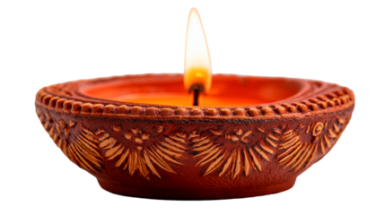 Traditional clay diya lamp with a burning wick placed on a simple surface during a cultural celebration