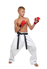 Muscular boy in white kimono and red gloves