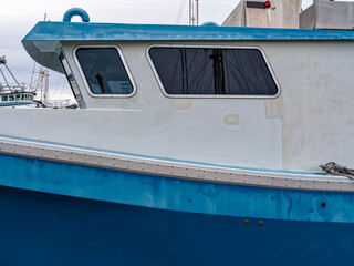 The cabin or wheelhouse of a commercial fishing vessel docked at a marina on the Pacific coast © davidrh