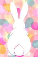 Back view of a white rabbit silhouette with long ears on a colorful background of overlapping Easter eggs.